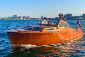 Private Copenhagen Boat cruise in Scandinavian mahogany boat - Following the city’s power line: Parliament, the old Exchange spire, and the royal church