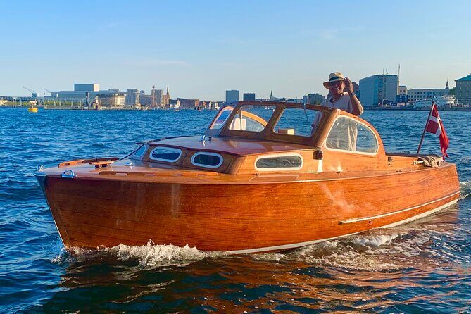 Private Copenhagen Boat cruise in Scandinavian mahogany boat - Following the city’s power line: Parliament, the old Exchange spire, and the royal church